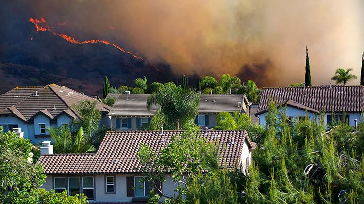 Wildfire approaching homes.